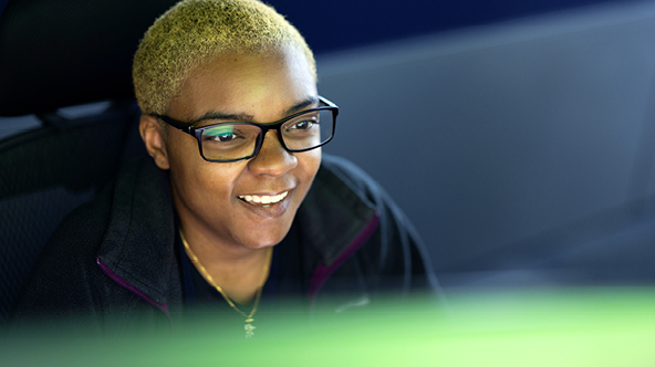 Birmingham Police Officer looking at a computer monitor and smiling